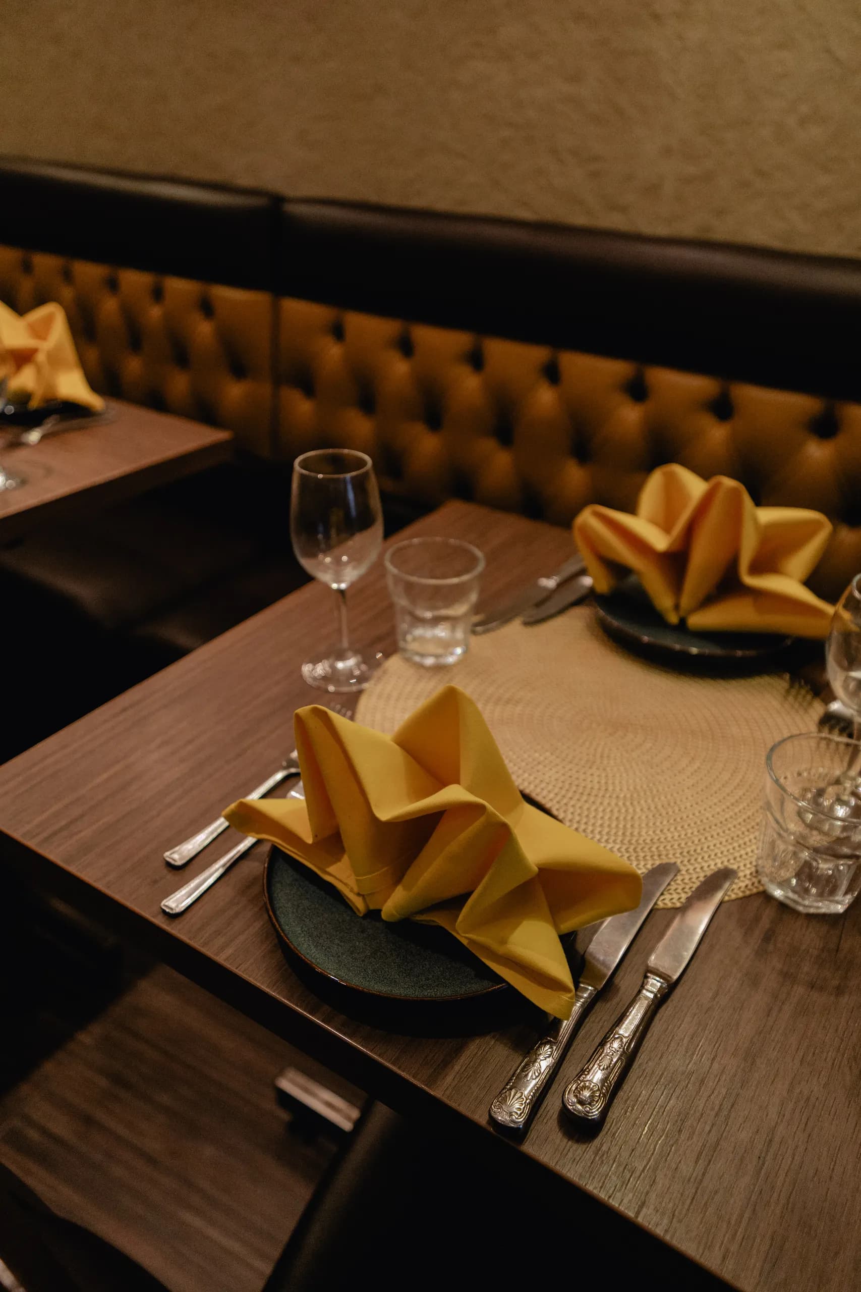 Banquette seating and laid tables in the Maharaja of India dining room