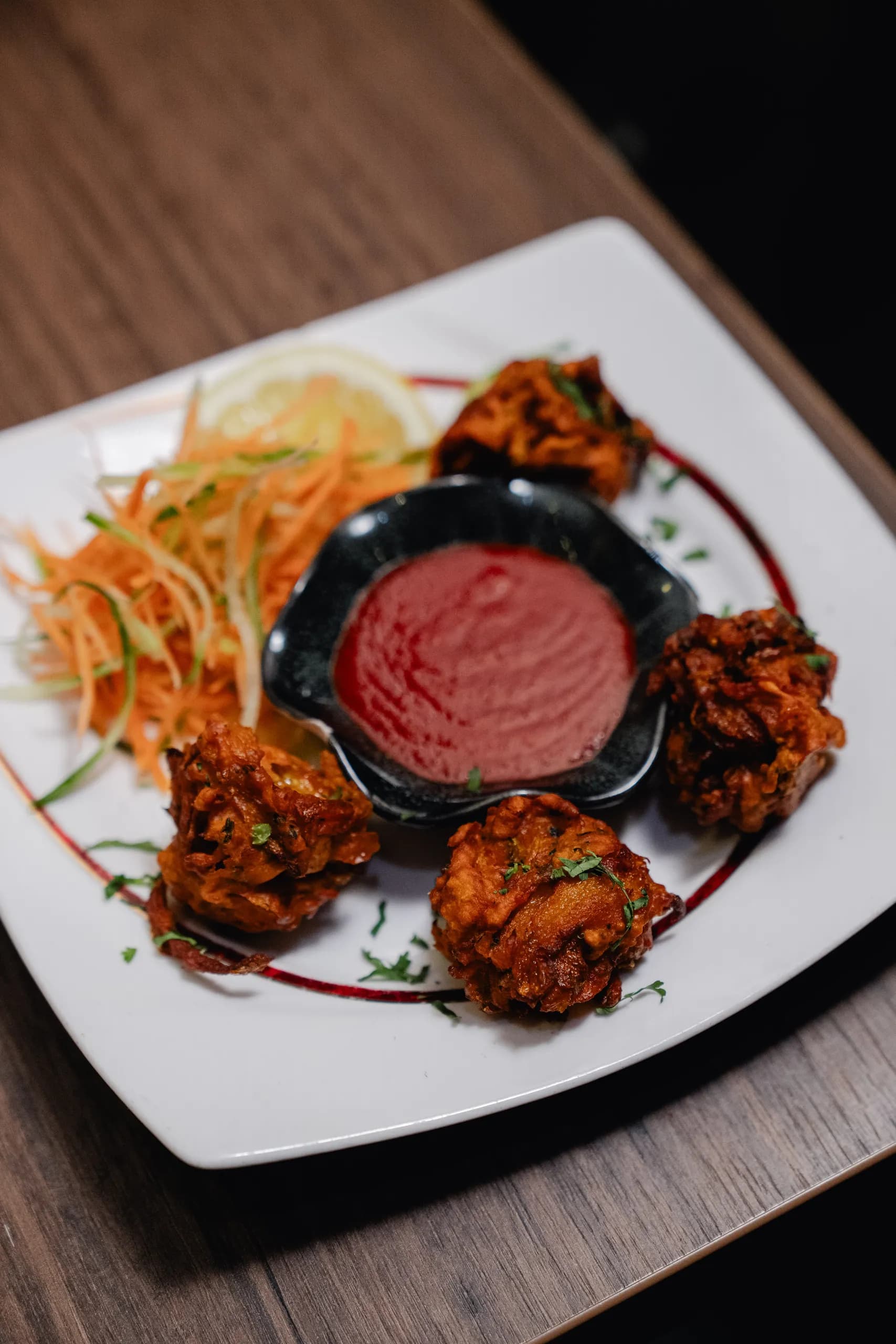 Onion bhaji served with a dipping sauce