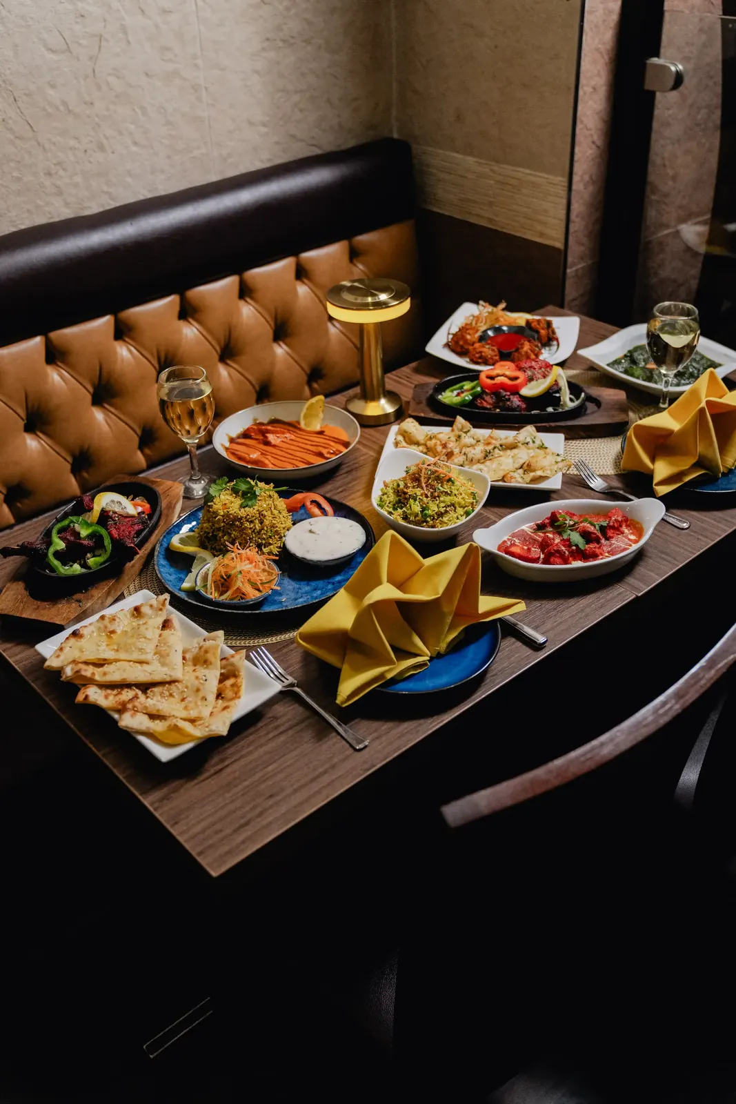 A table set for dinner in the Maharaja of India dining room, with curries, tandoori, naan and rice